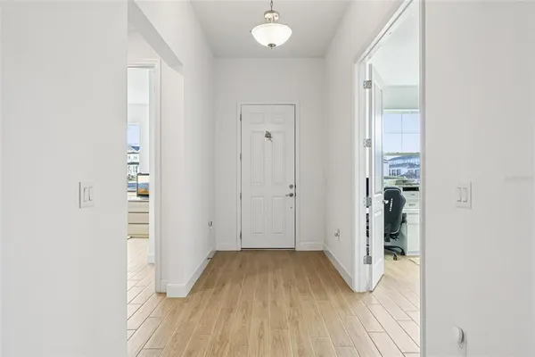 a living room with furniture and large windows