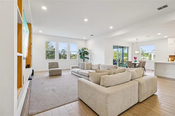 a living room with furniture a potted plant and a potted plant