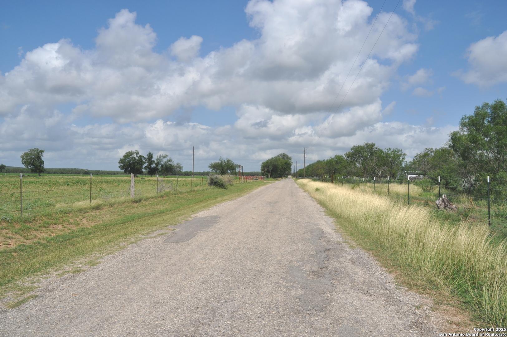 Tbd Cr 662 Devine, TX 78016 - Photo 7 of 8 a view of a lake with a big yard and large trees