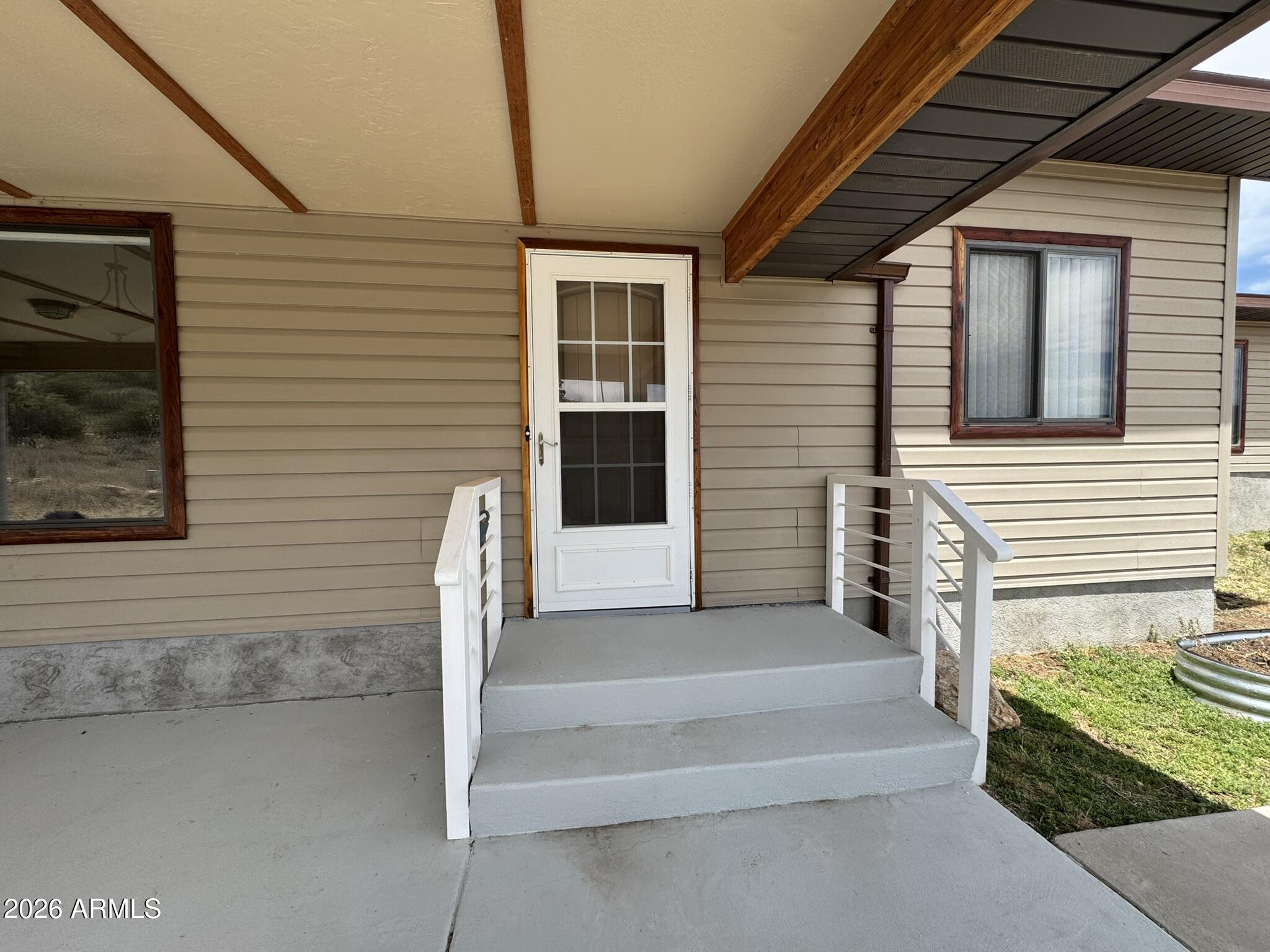 18168 Spoon Road Kirkland, AZ 86332 - Photo 11 of 59 a front view of a house with stairs
