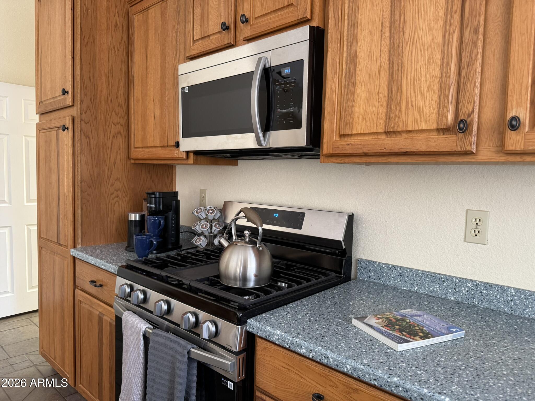 18168 Spoon Road Kirkland, AZ 86332 - Photo 15 of 59 a kitchen with stainless steel appliances granite countertop a stove and a microwave