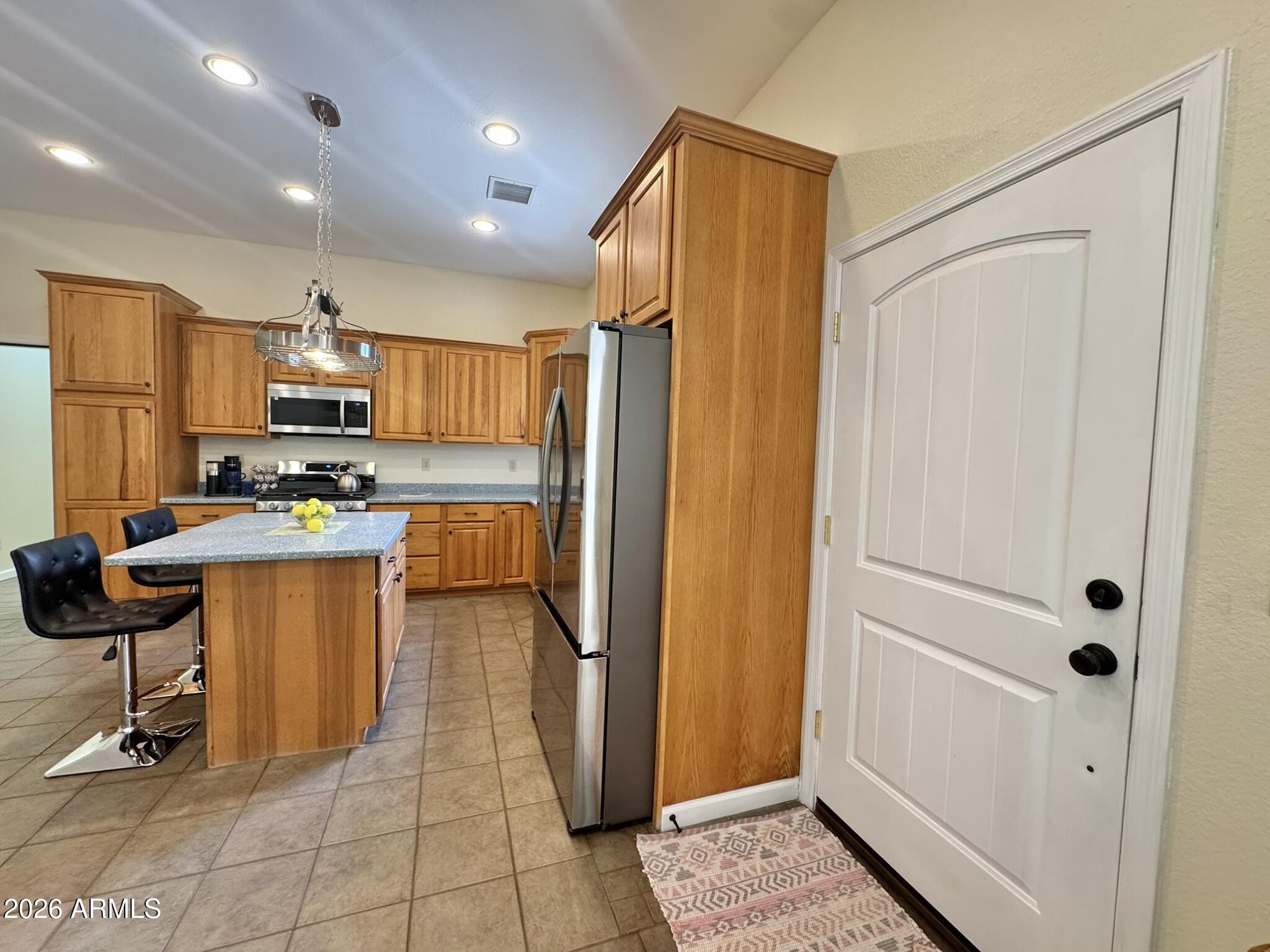 18168 Spoon Road Kirkland, AZ 86332 - Photo 16 of 59 a kitchen with granite countertop a refrigerator and a sink
