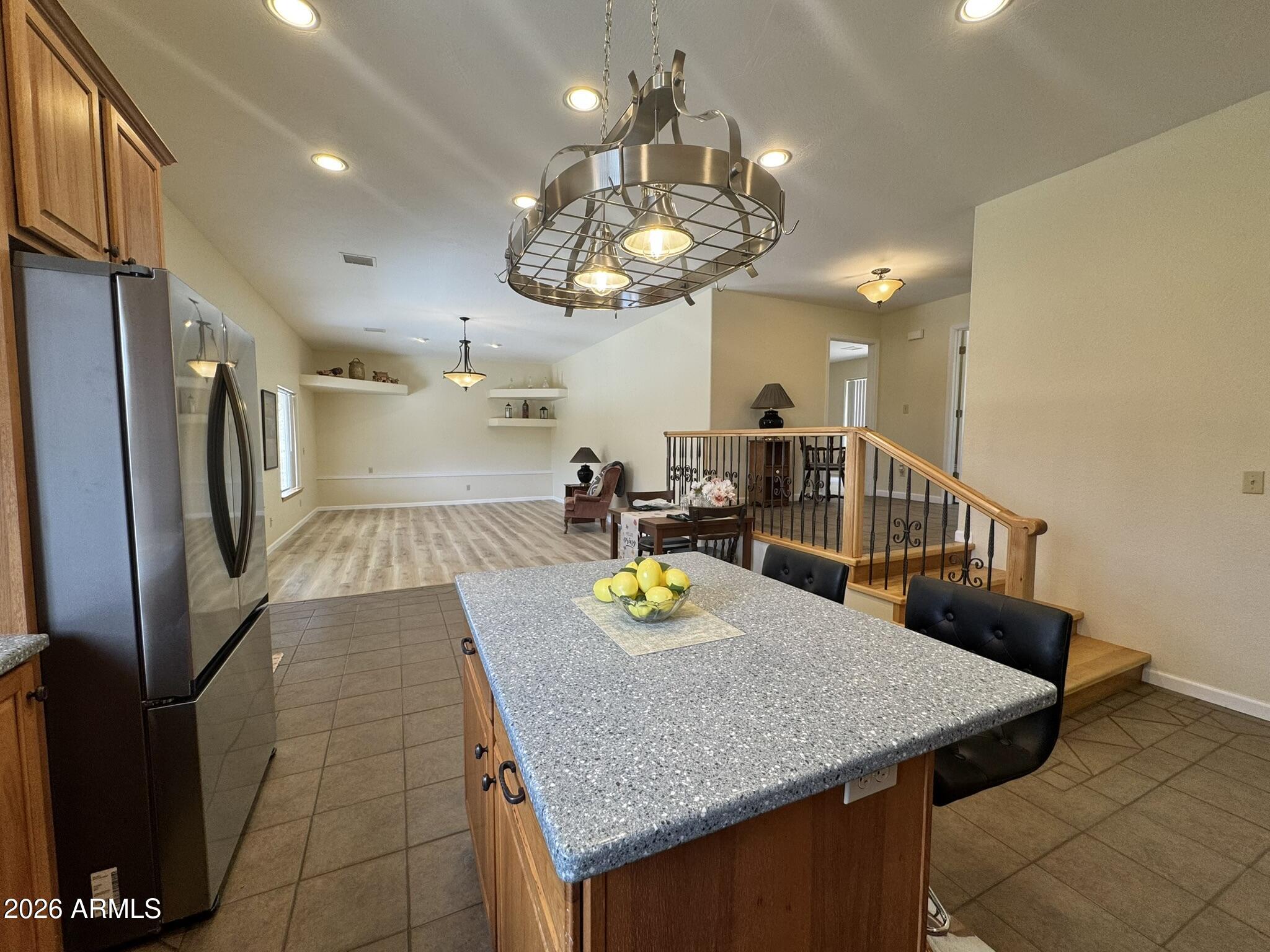 18168 Spoon Road Kirkland, AZ 86332 - Photo 17 of 59 a kitchen with stainless steel appliances granite countertop a sink a refrigerator and a granite counter tops