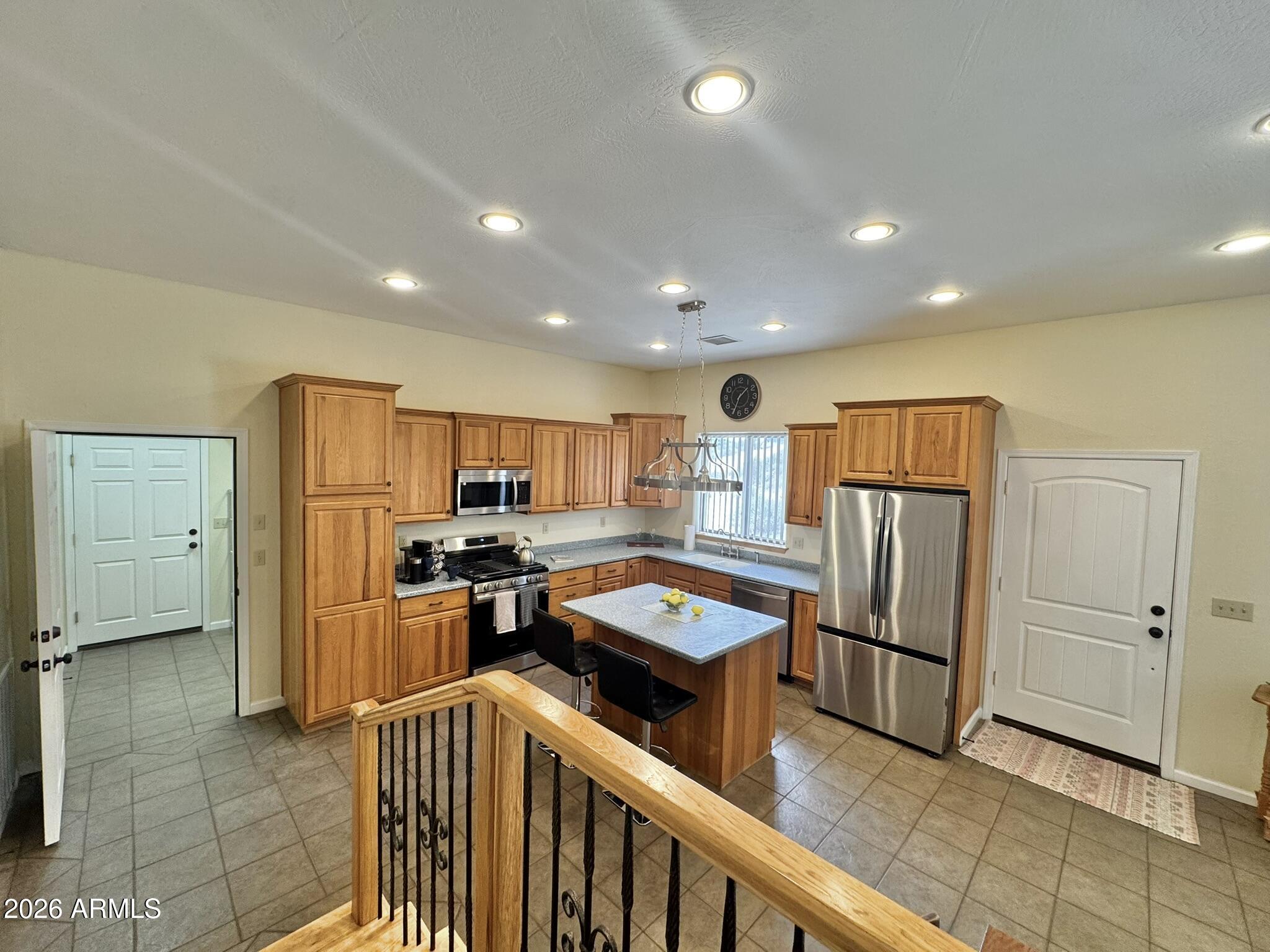 18168 Spoon Road Kirkland, AZ 86332 - Photo 19 of 59 a kitchen with stainless steel appliances a refrigerator and a stove top oven