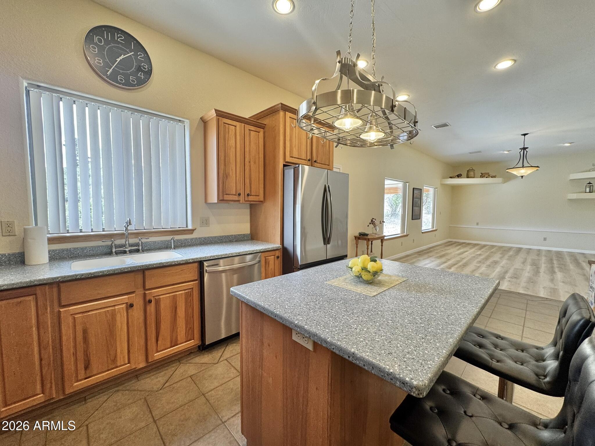 18168 Spoon Road Kirkland, AZ 86332 - Photo 2 of 59 a kitchen with cabinets and chandelier