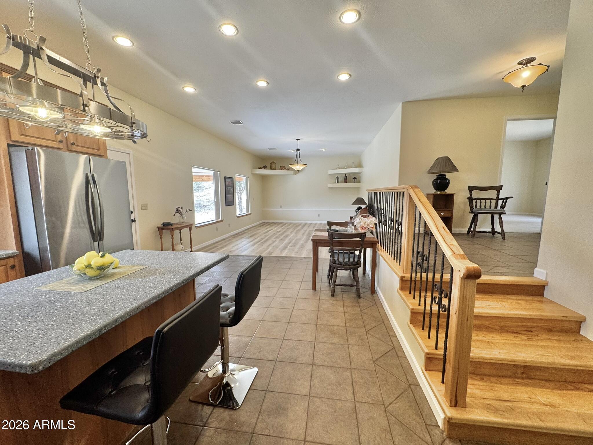18168 Spoon Road Kirkland, AZ 86332 - Photo 21 of 59 a dining hall with stainless steel appliances granite countertop a stove and a refrigerator