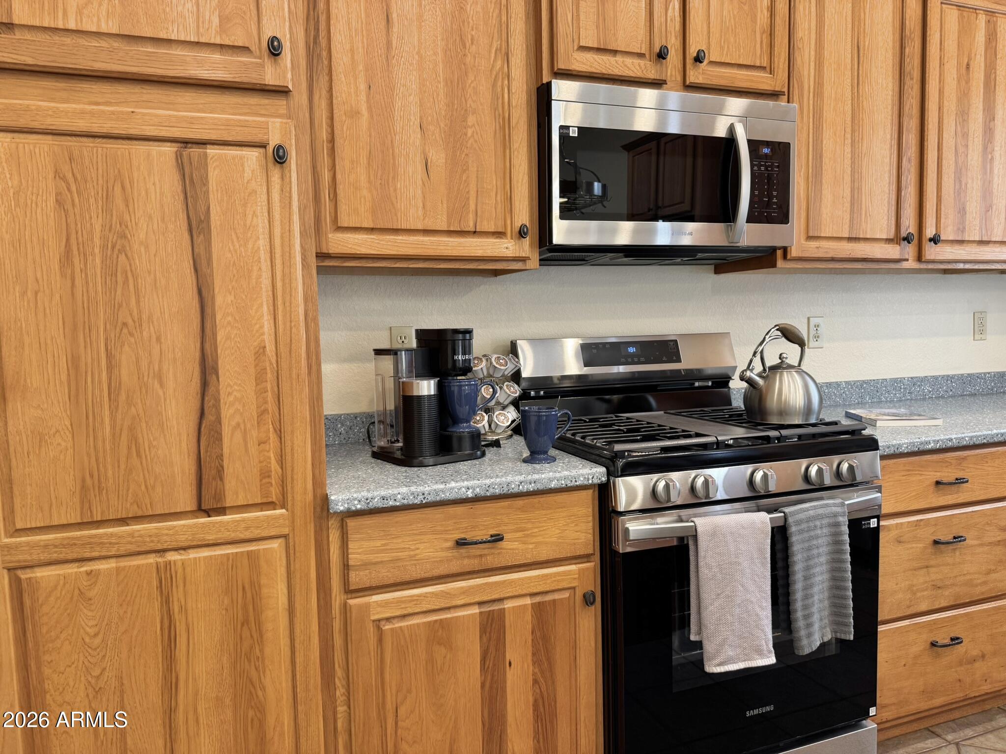 18168 Spoon Road Kirkland, AZ 86332 - Photo 23 of 59 a kitchen with stainless steel appliances granite countertop white cabinets and a stove top oven