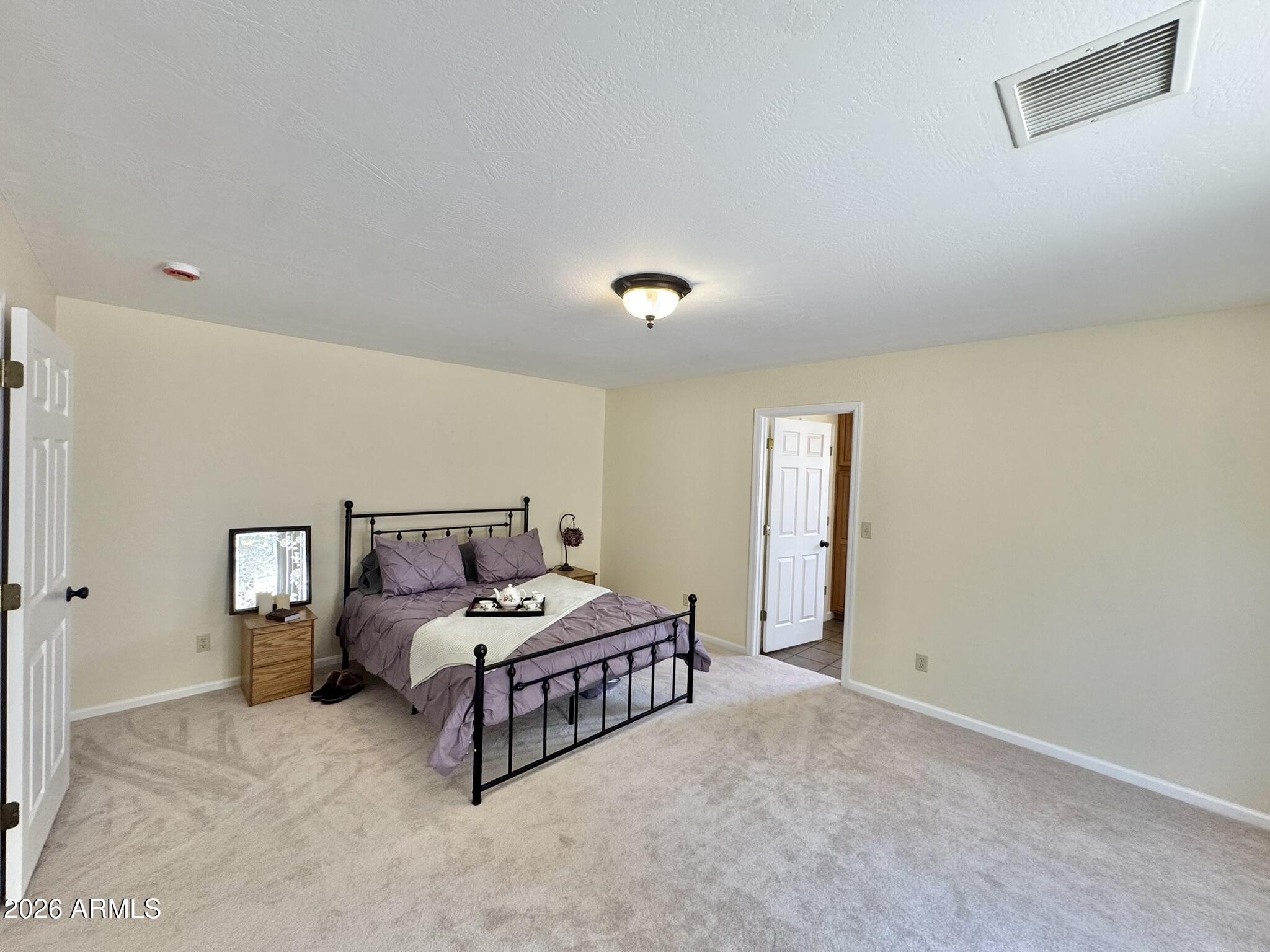 18168 Spoon Road Kirkland, AZ 86332 - Photo 3 of 59 a bedroom with a bed and a window