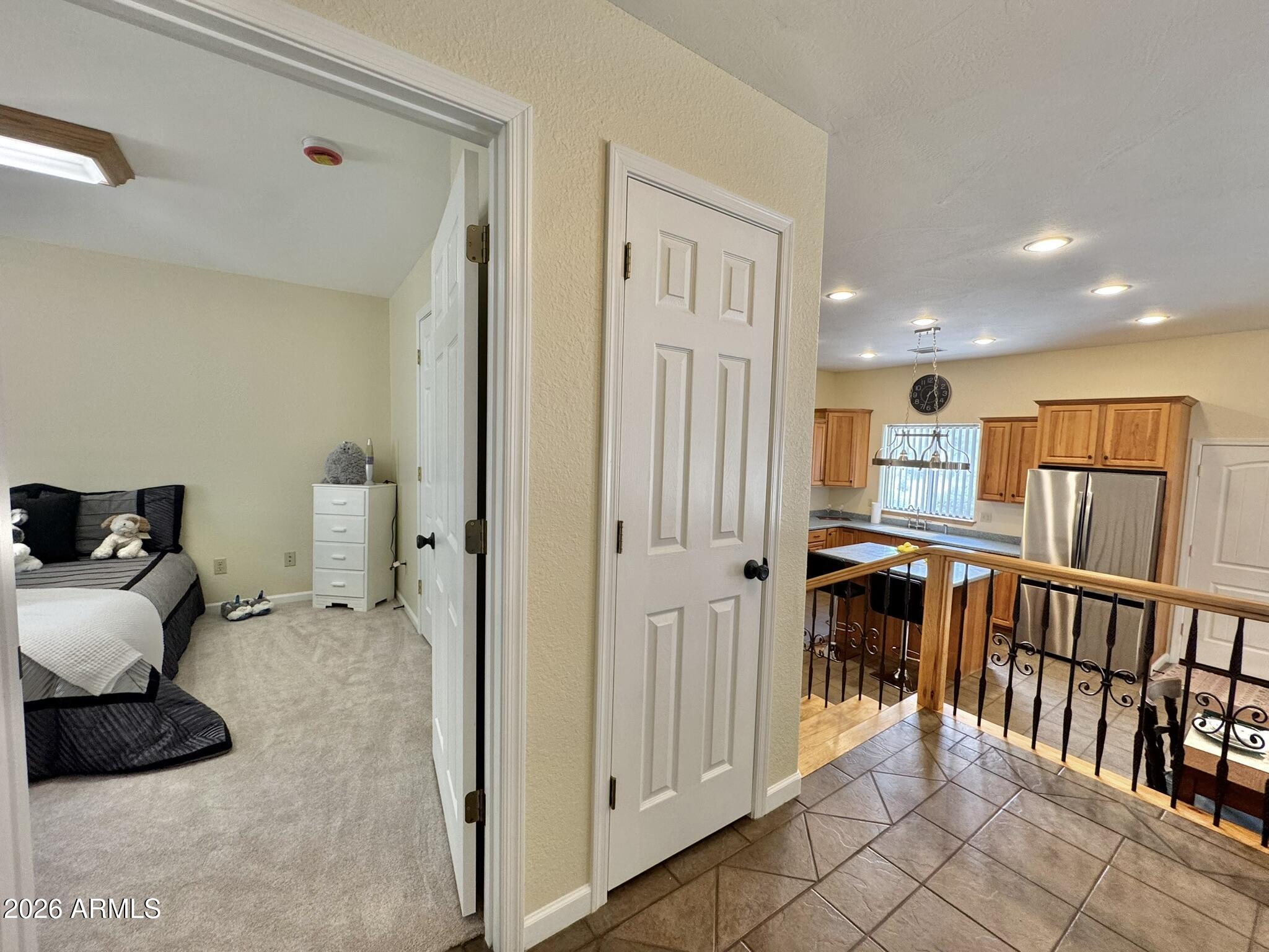 18168 Spoon Road Kirkland, AZ 86332 - Photo 32 of 59 a view of a hallway with bedroom and workspace