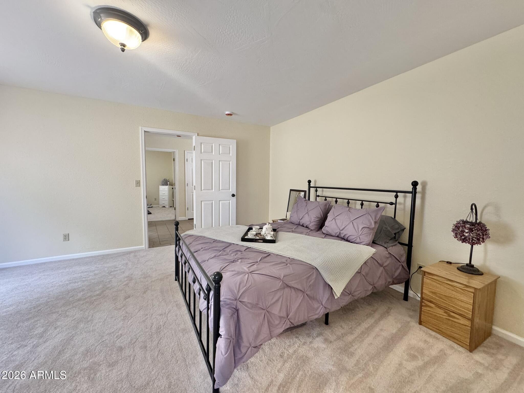 18168 Spoon Road Kirkland, AZ 86332 - Photo 33 of 59 a bedroom with a bed and a couch