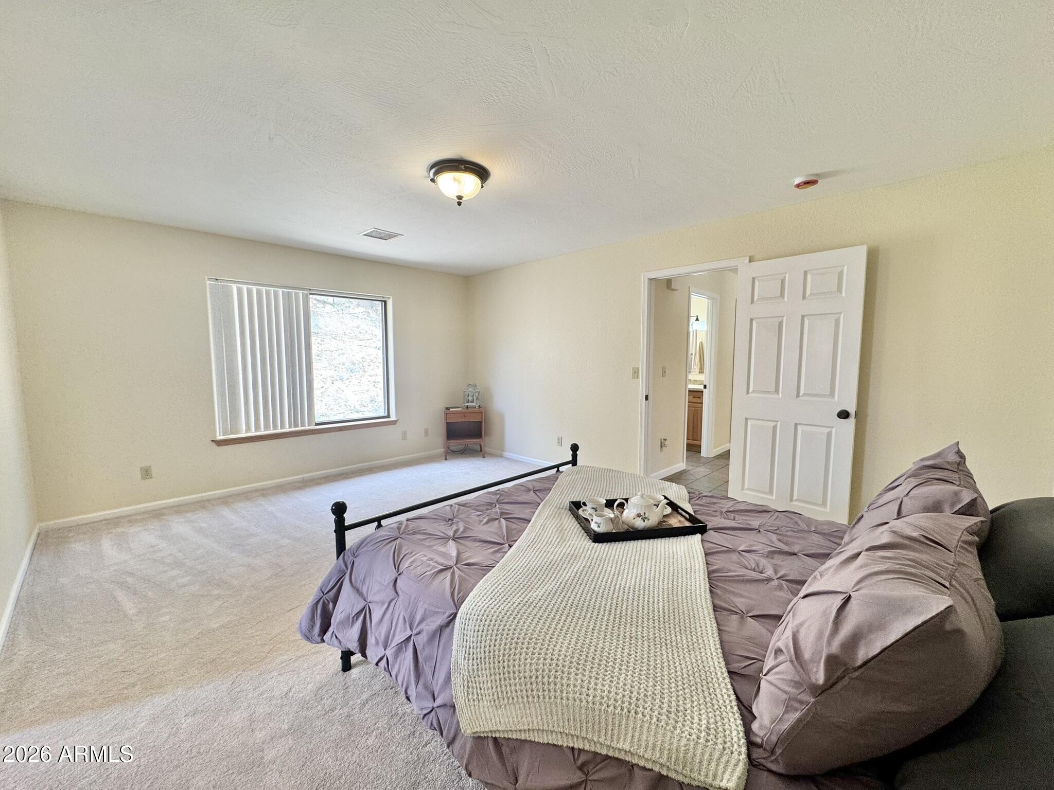 18168 Spoon Road Kirkland, AZ 86332 - Photo 34 of 59 a bedroom with a bed and wooden floor