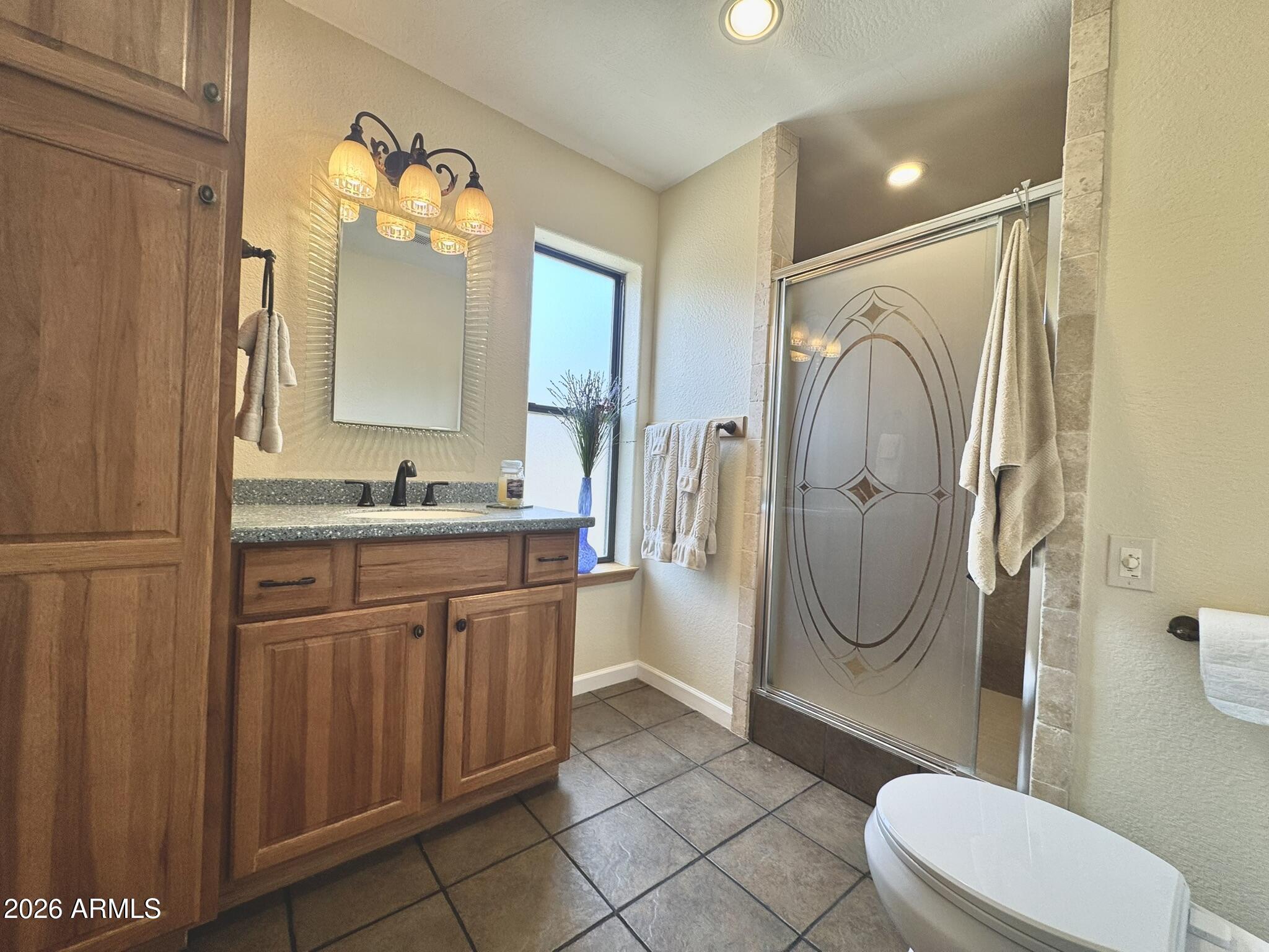 18168 Spoon Road Kirkland, AZ 86332 - Photo 35 of 59 a bathroom with a granite countertop sink toilet and shower