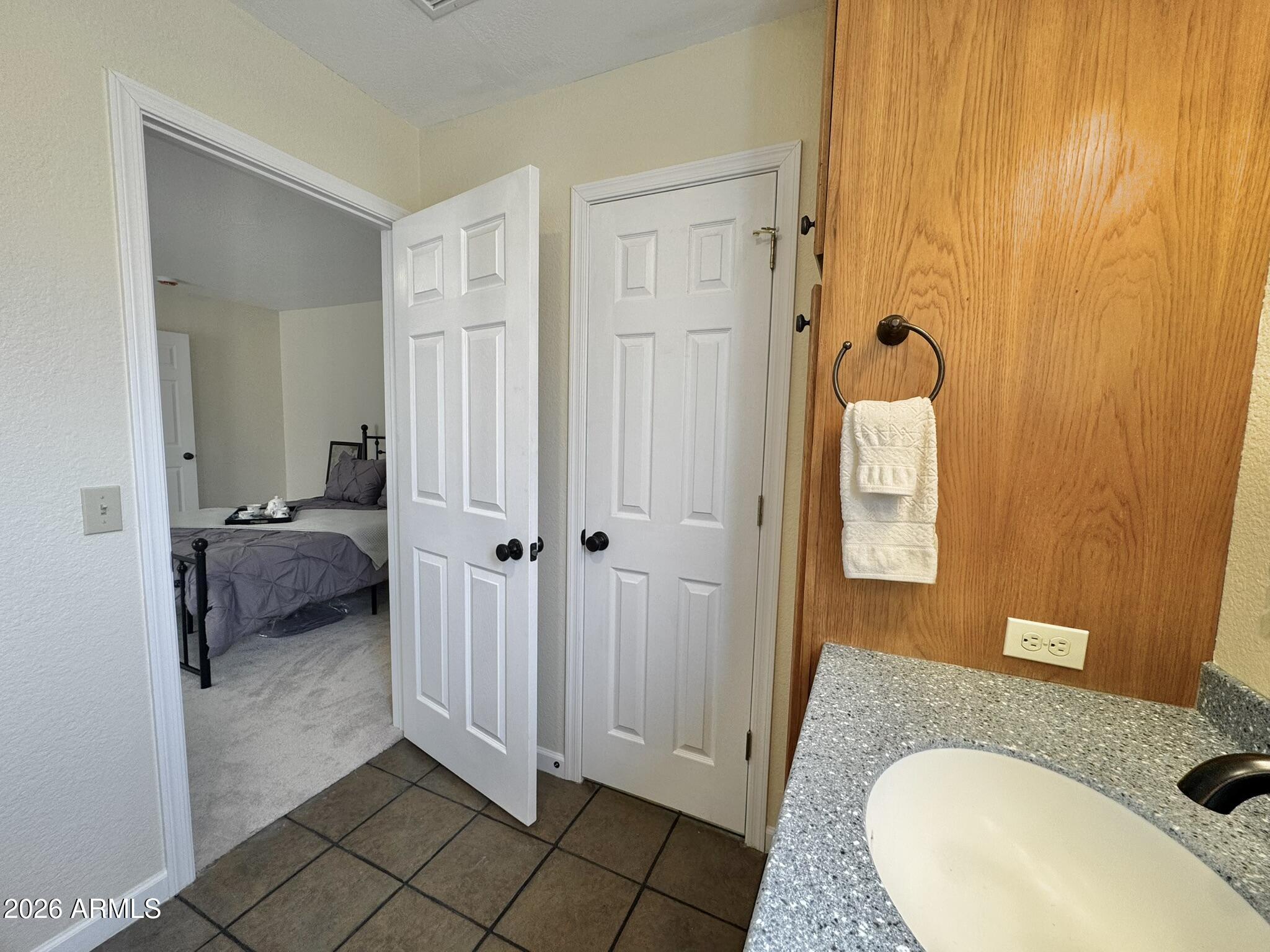18168 Spoon Road Kirkland, AZ 86332 - Photo 36 of 59 a en suite bathroom with a granite countertop sink and a mirror