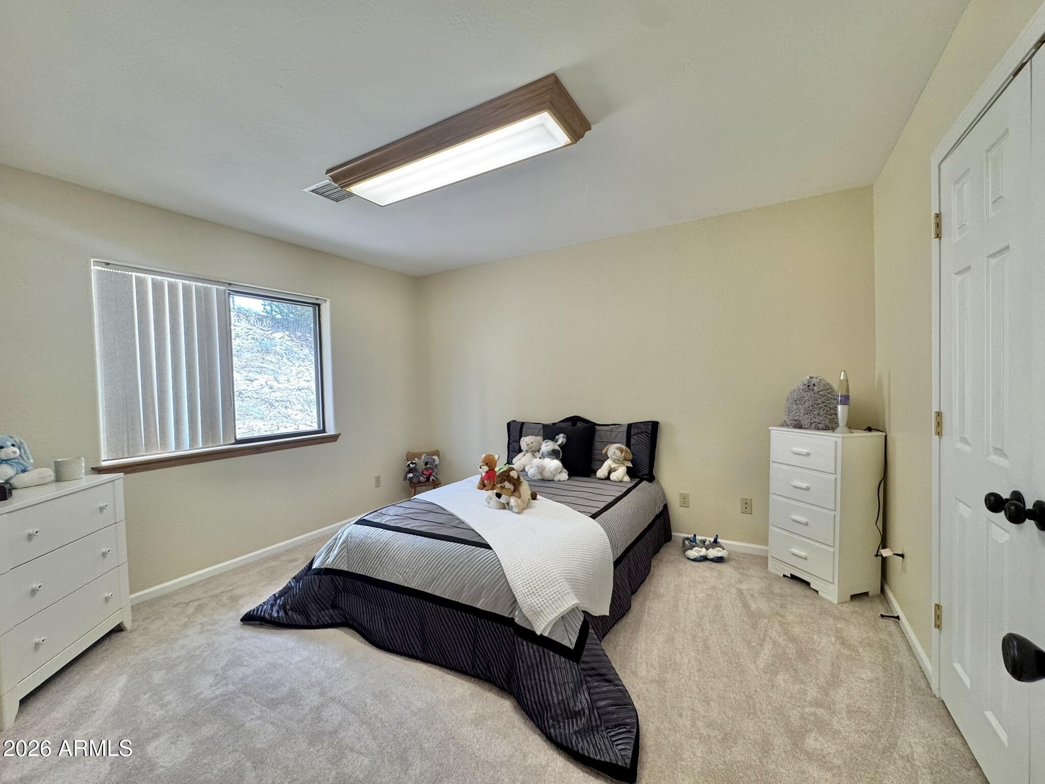 18168 Spoon Road Kirkland, AZ 86332 - Photo 42 of 59 a bed room with a bed and a window