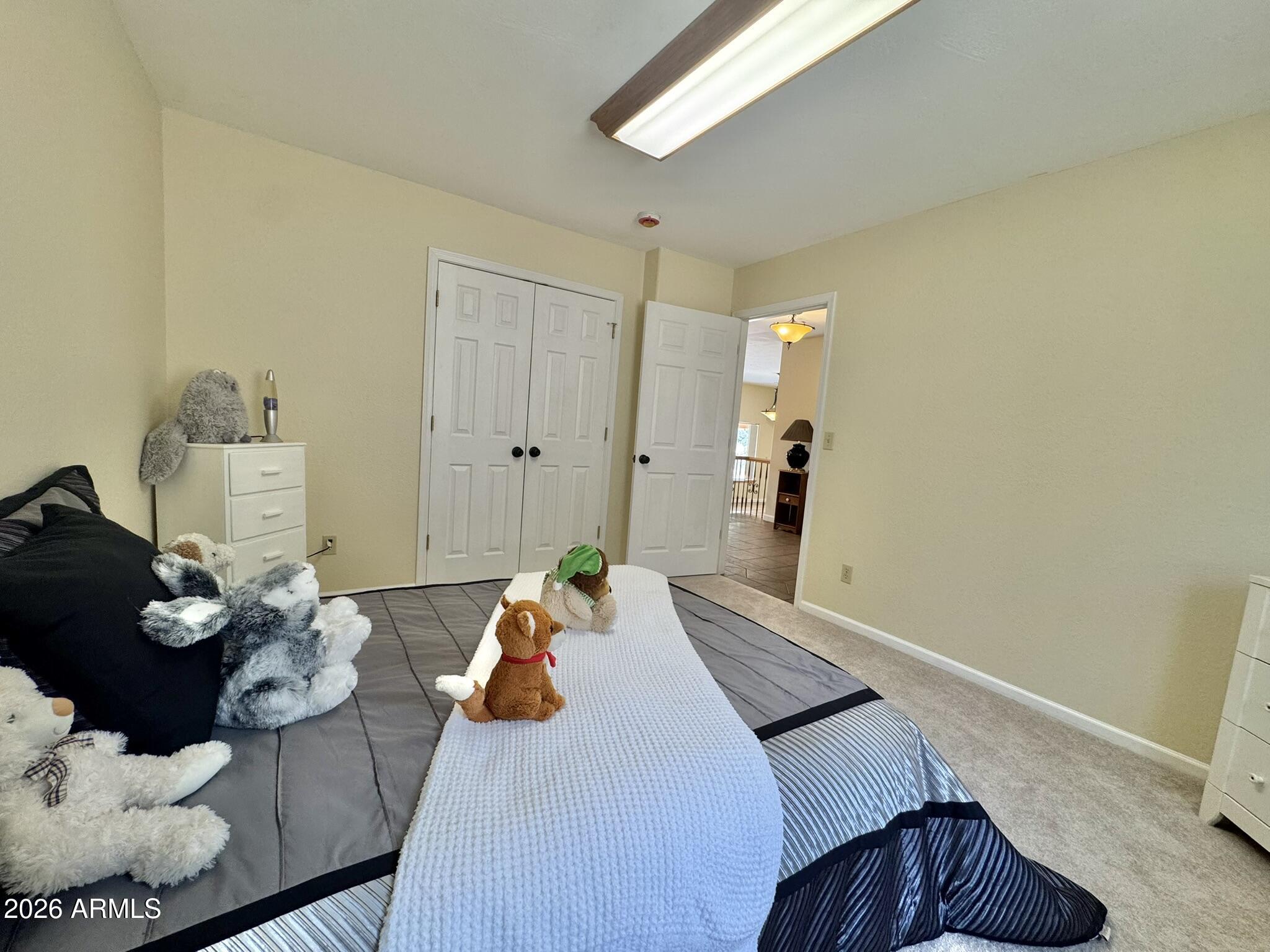 18168 Spoon Road Kirkland, AZ 86332 - Photo 43 of 59 a bedroom with a bed and wooden floor