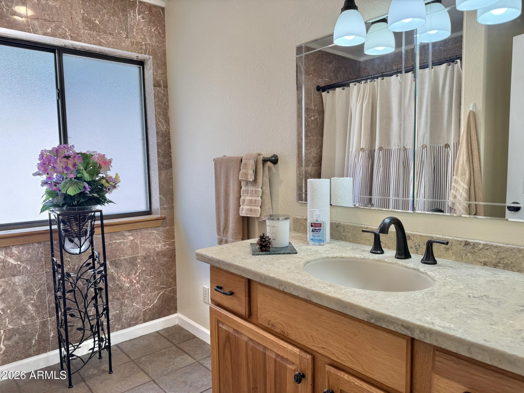18168 Spoon Road Kirkland, AZ 86332 - Photo 44 of 59 a bathroom with a granite countertop sink a potted plant and a shower
