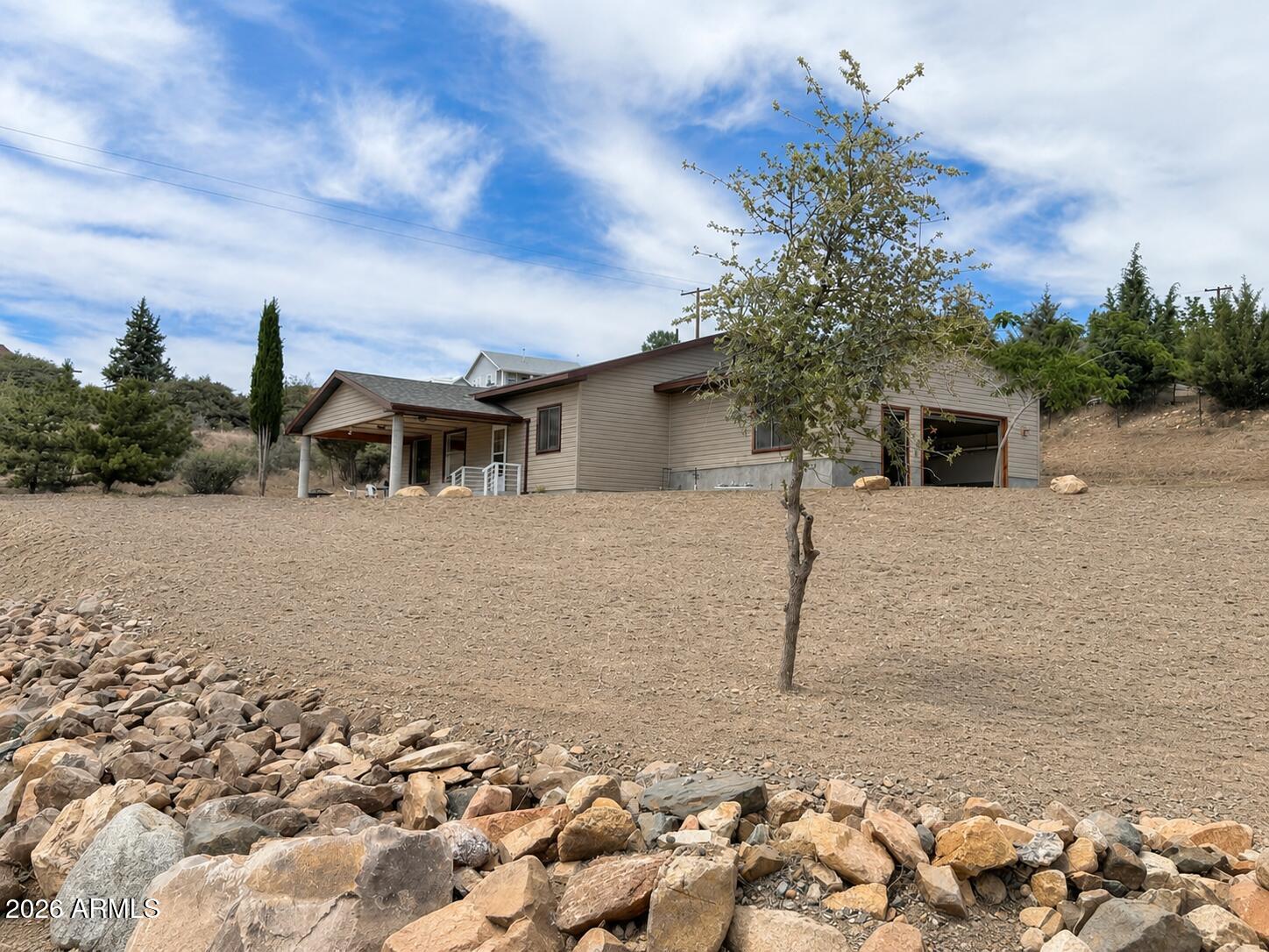 18168 Spoon Road Kirkland, AZ 86332 - Photo 52 of 59 a backyard of a house with lots of green space