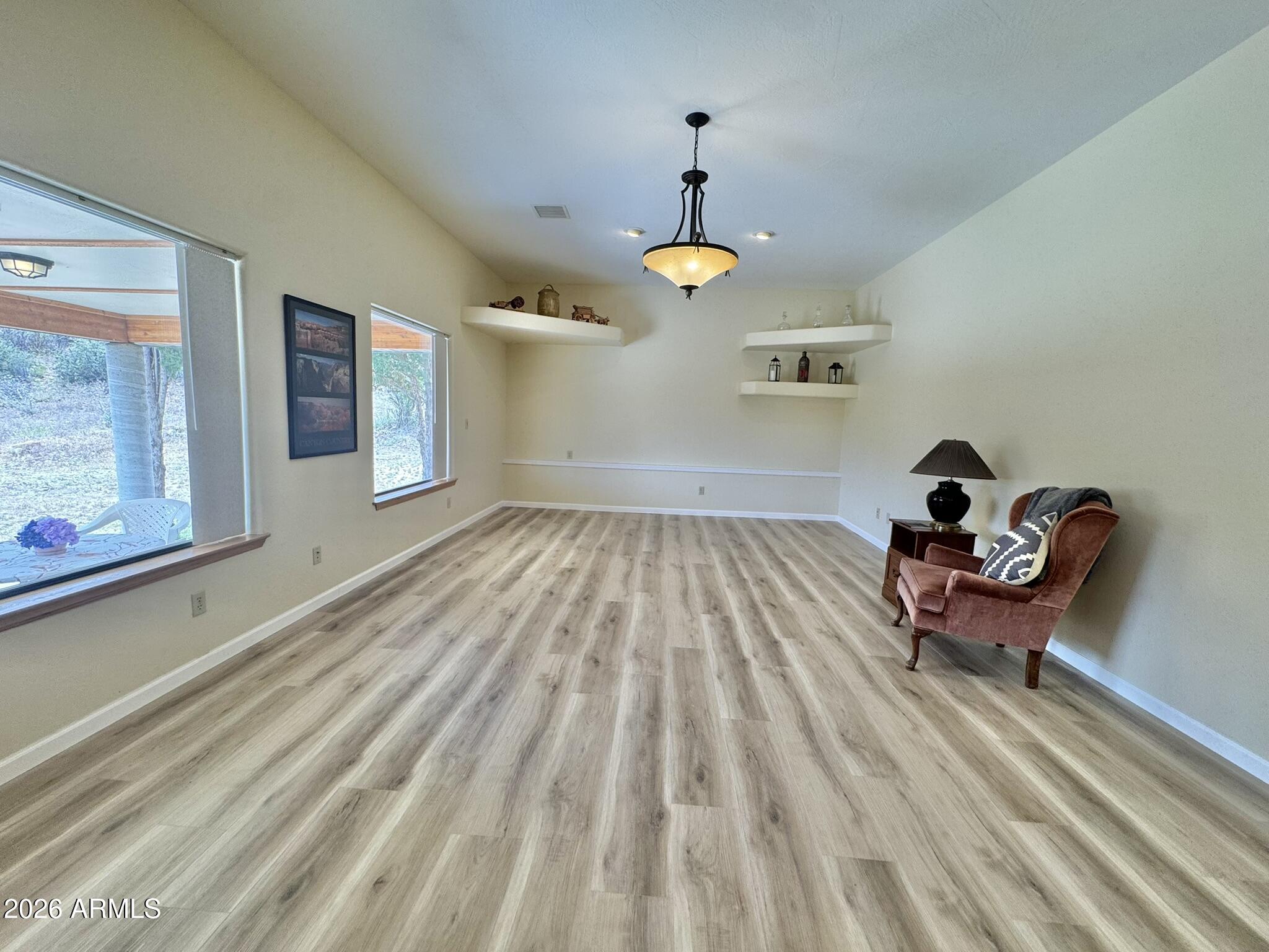 18168 Spoon Road Kirkland, AZ 86332 - Photo 57 of 59 a room with gym equipment and wooden floor