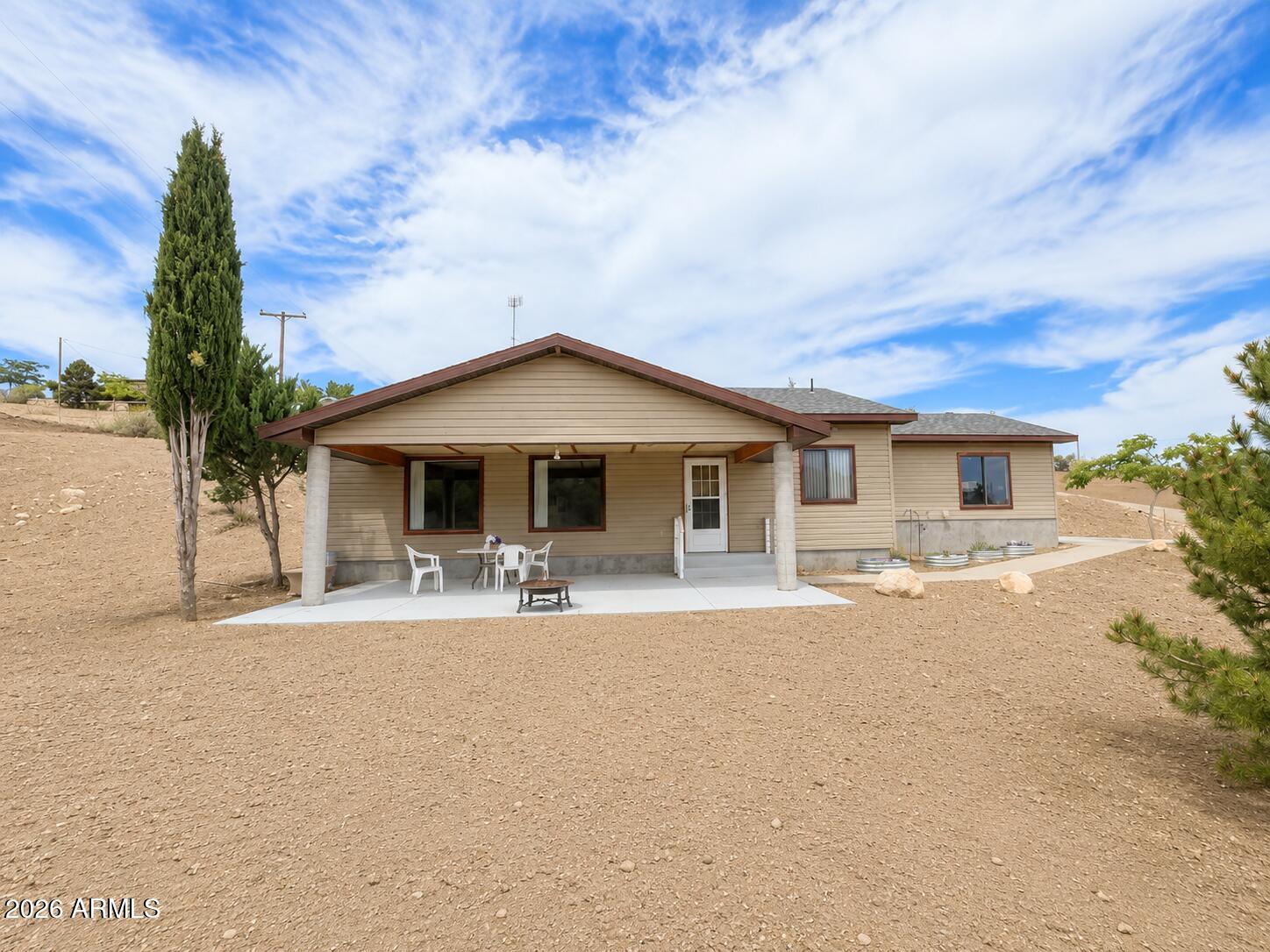 18168 Spoon Road Kirkland, AZ 86332 - Photo 6 of 59 front view of a house with a patio