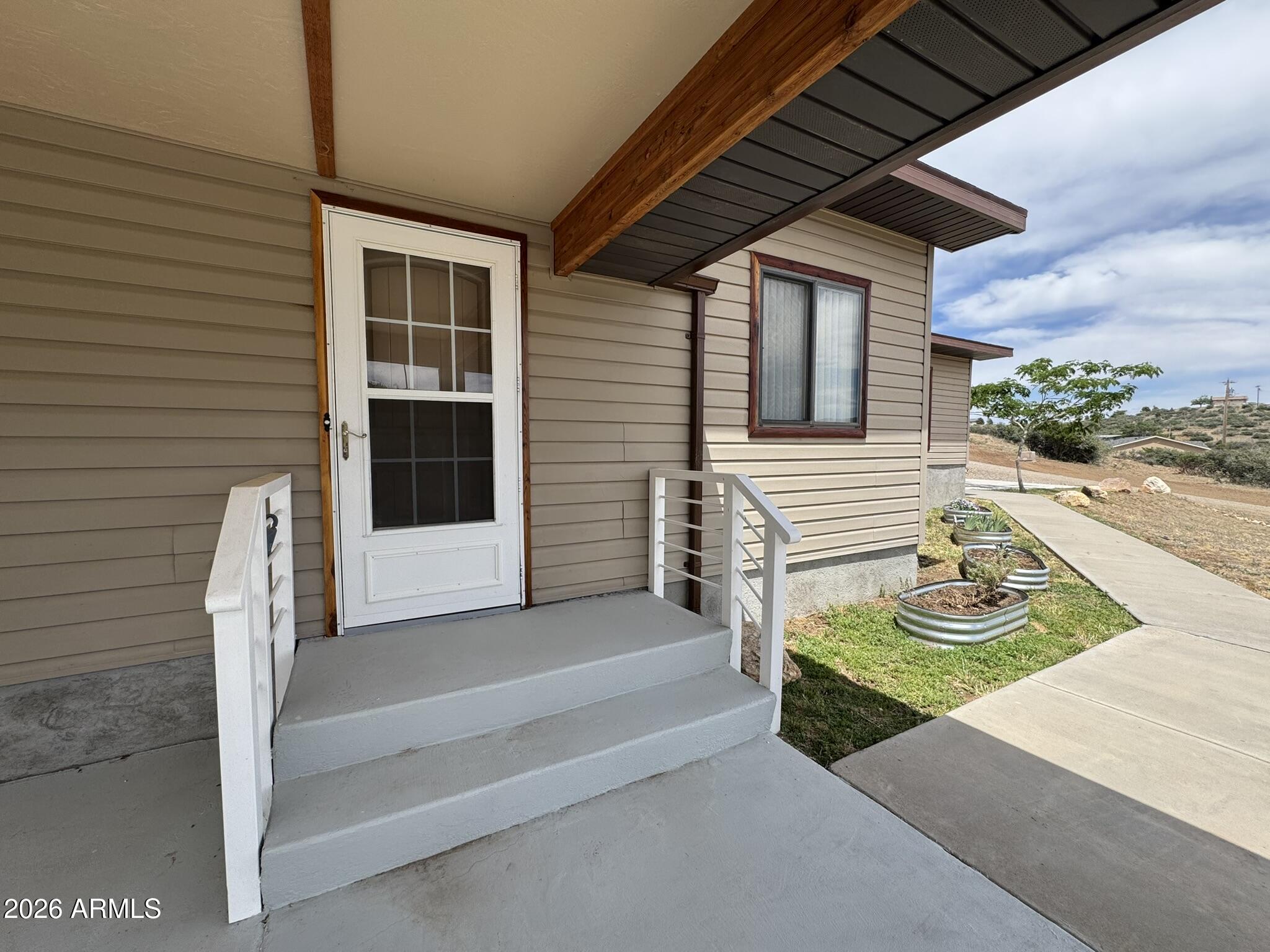 18168 Spoon Road Kirkland, AZ 86332 - Photo 8 of 59 a house view with a backyard space
