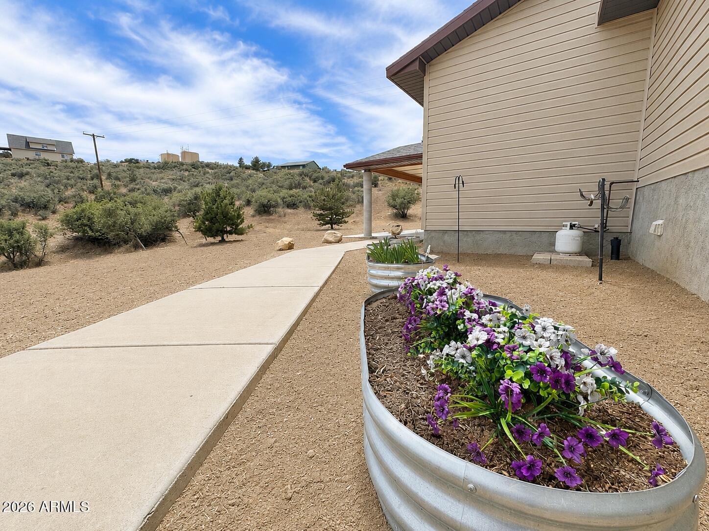 18168 Spoon Road Kirkland, AZ 86332 - Photo 10 of 59 a view of a garden with flowers and flowers