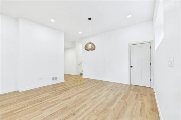 a view of a room with wooden floor and fan