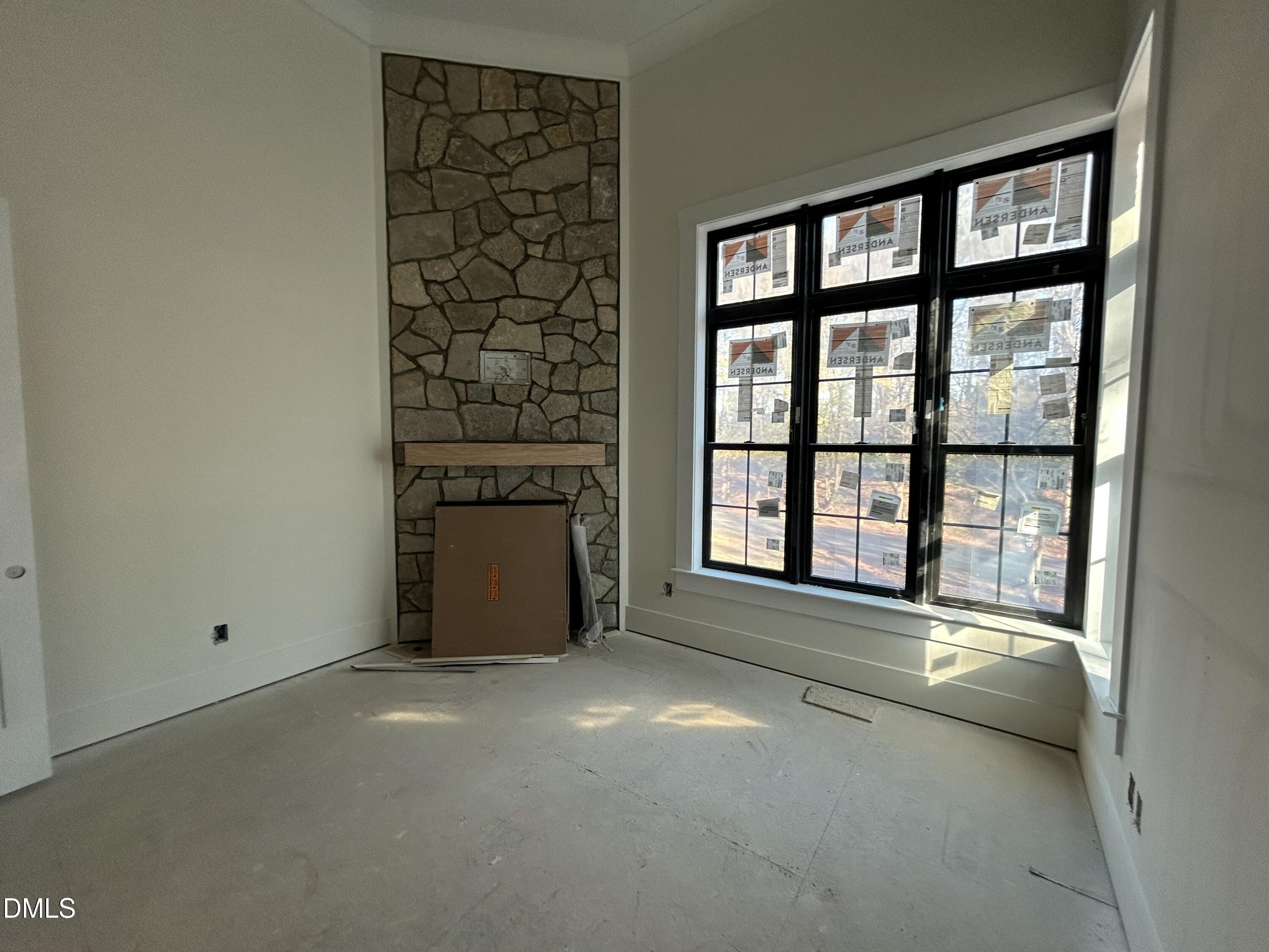 105 Edenburgh Road Raleigh, NC 27608 - Photo 13 of 26 a view of an empty room with a fireplace and a window