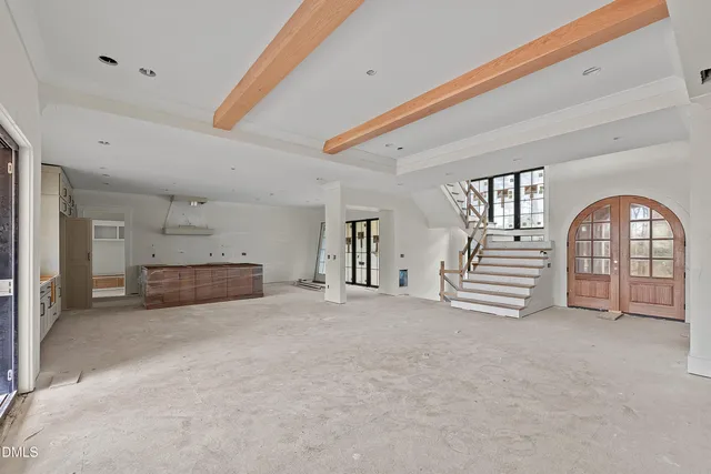 a view of an empty room with a fireplace and cabinet