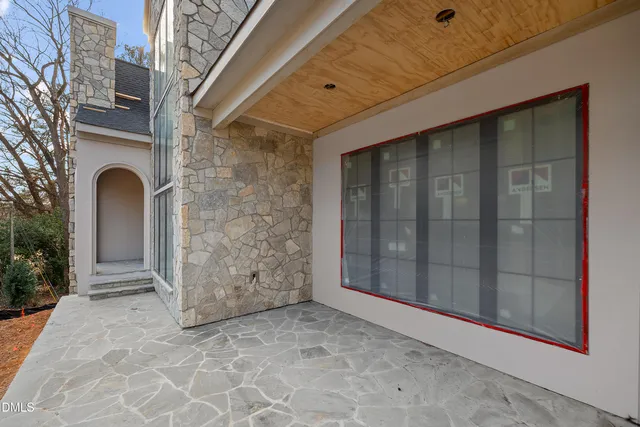a view of an empty room with a fireplace and a window