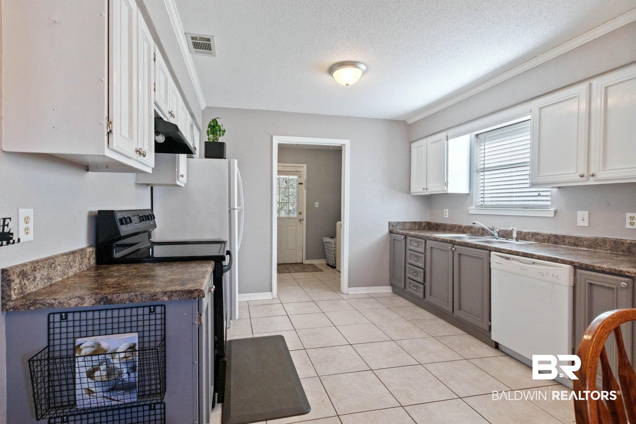 5366 Scanlan Way West Satsuma, AL 36572 - Photo 9 of 43 Kitchen with dark countertops, electric range, white dishwasher, light tile patterned floors, and a textured ceiling
