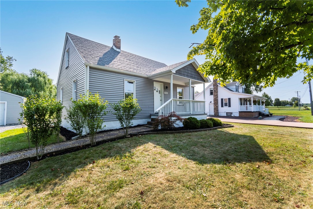 8131 Struthers Road Lowellville, OH 44436 - Photo 5 of 48 Bungalow-style home with a front yard and covered porch