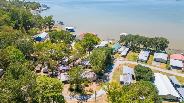 an aerial view of a house with a yard and garden