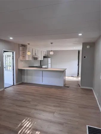 a view of a kitchen with a sink and a refrigerator