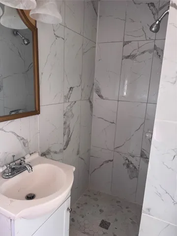 a bathroom with a sink and shower