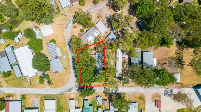 an aerial view of a house with a yard and garden