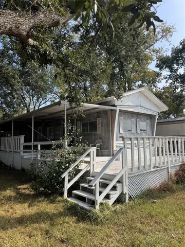 a view of a house with backyard and sitting area