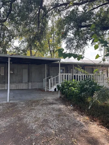a front view of house with a garden
