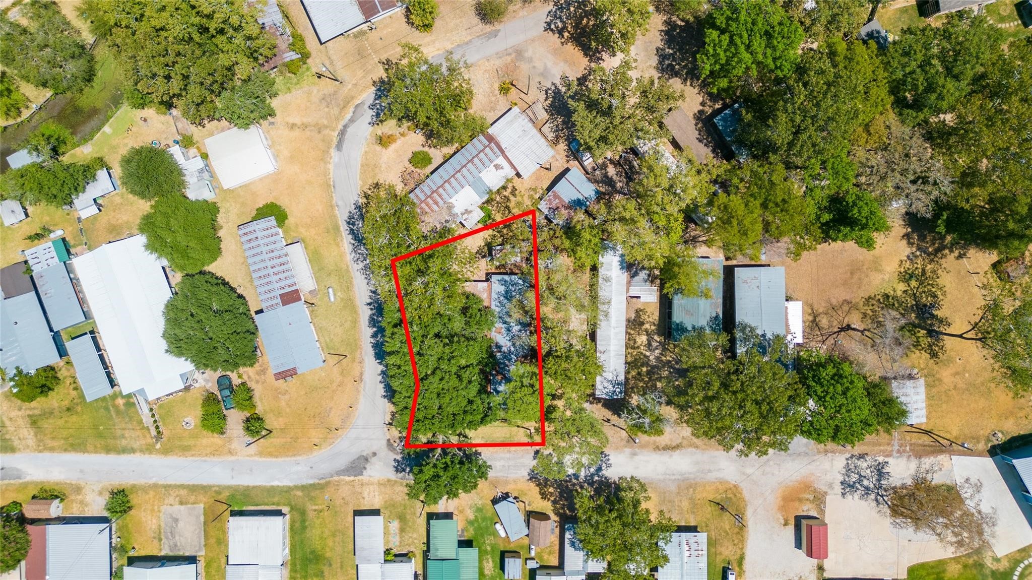 251 Ramp Way Trinity, TX 75862 - Photo 2 of 18 an aerial view of a house with a yard and garden
