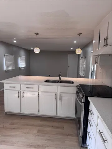 a kitchen with a sink and cabinets