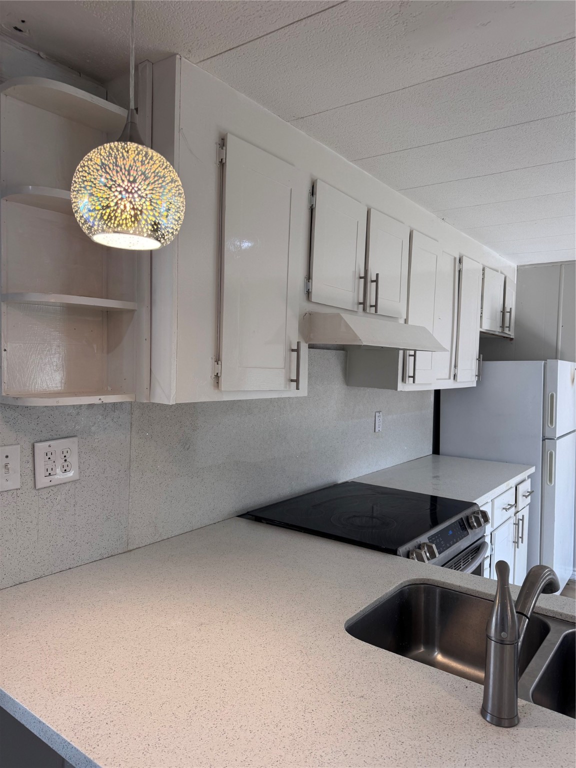 251 Ramp Way Trinity, TX 75862 - Photo 4 of 18 a kitchen with kitchen island a sink a stove and refrigerator