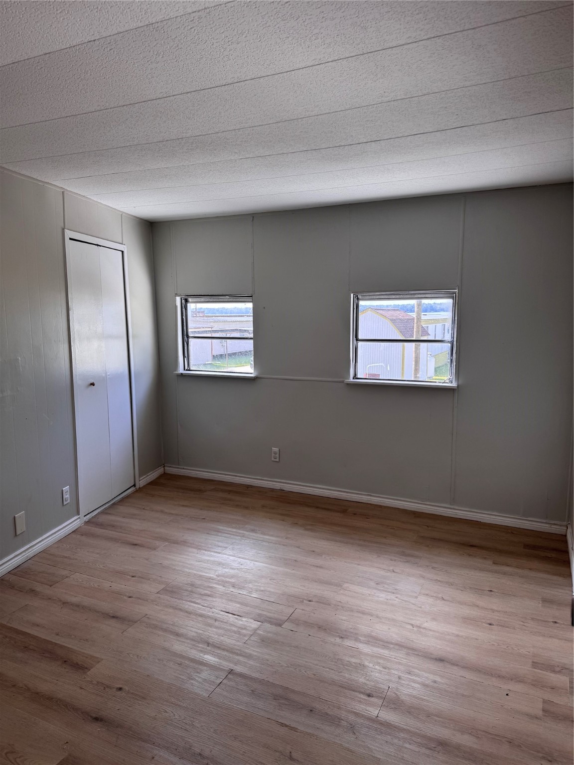 251 Ramp Way Trinity, TX 75862 - Photo 10 of 18 a view of an empty room with wooden floor and a window