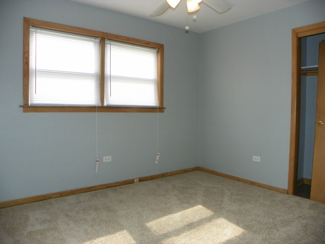 10108 South Pulaski Road, Unit 1S Oak Lawn, IL 60453 - Photo 6 of 8 an empty room with a window