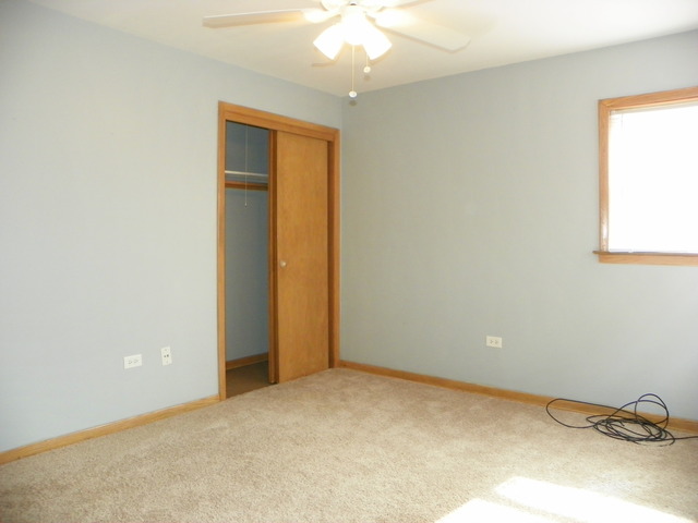 10108 South Pulaski Road, Unit 1S Oak Lawn, IL 60453 - Photo 8 of 8 an empty room with a ceiling fan and a window