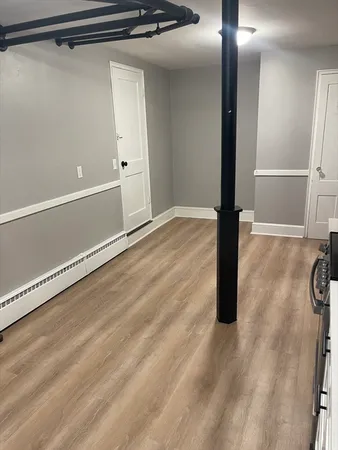 a view of a room with wooden floor and windows