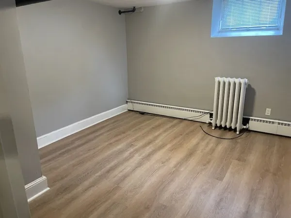 a view of an empty room and wooden floor