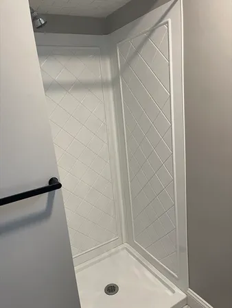 a bathroom with a glass shower door