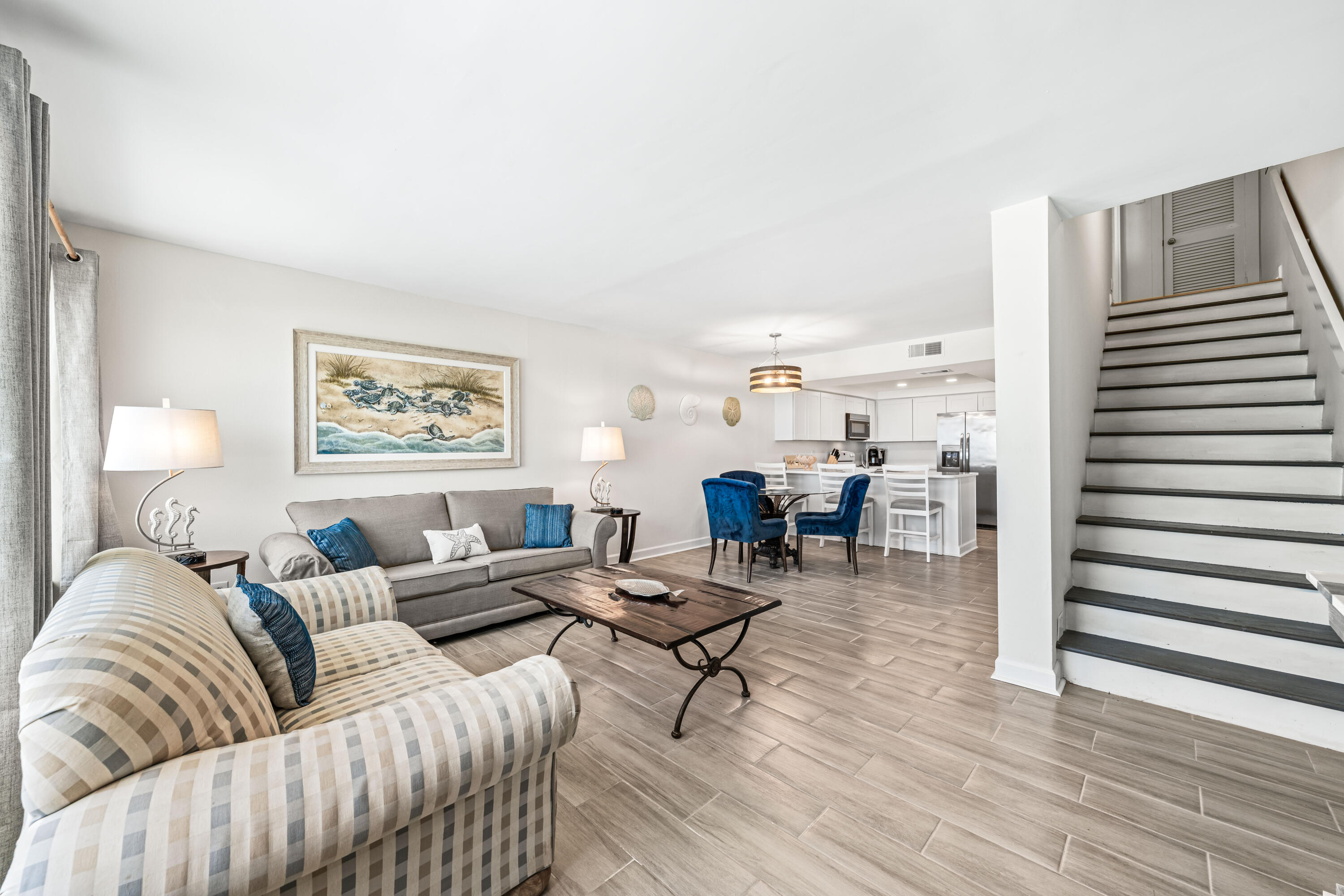 22519 Front Beach Road, Unit 108 Panama City Beach, FL 32413 - Photo 11 of 38 a living room with furniture and a wooden floor
