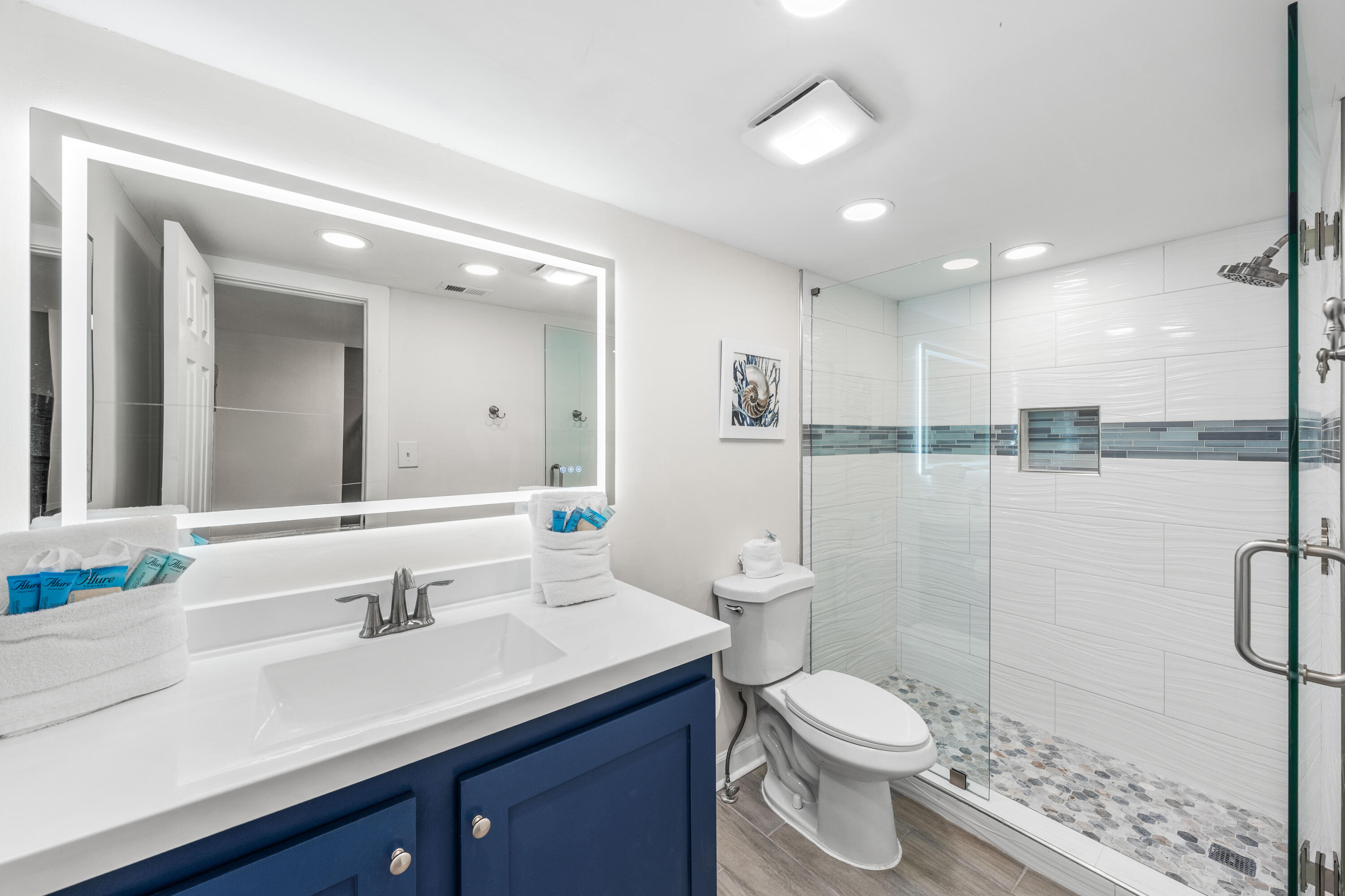 22519 Front Beach Road, Unit 108 Panama City Beach, FL 32413 - Photo 14 of 38 a bathroom with a toilet a sink and mirror