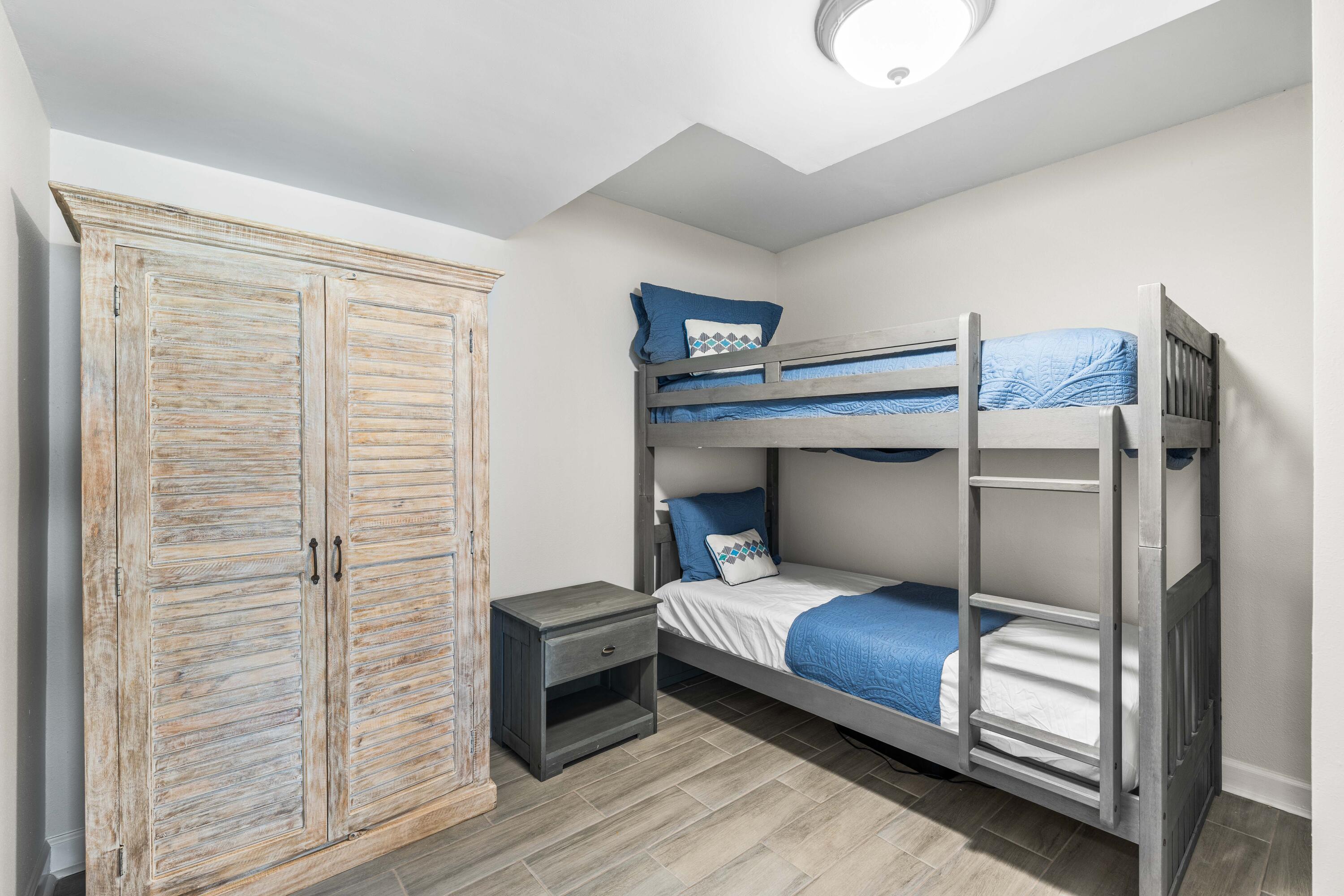 22519 Front Beach Road, Unit 108 Panama City Beach, FL 32413 - Photo 15 of 38 a bedroom with a bed and a walk in closet