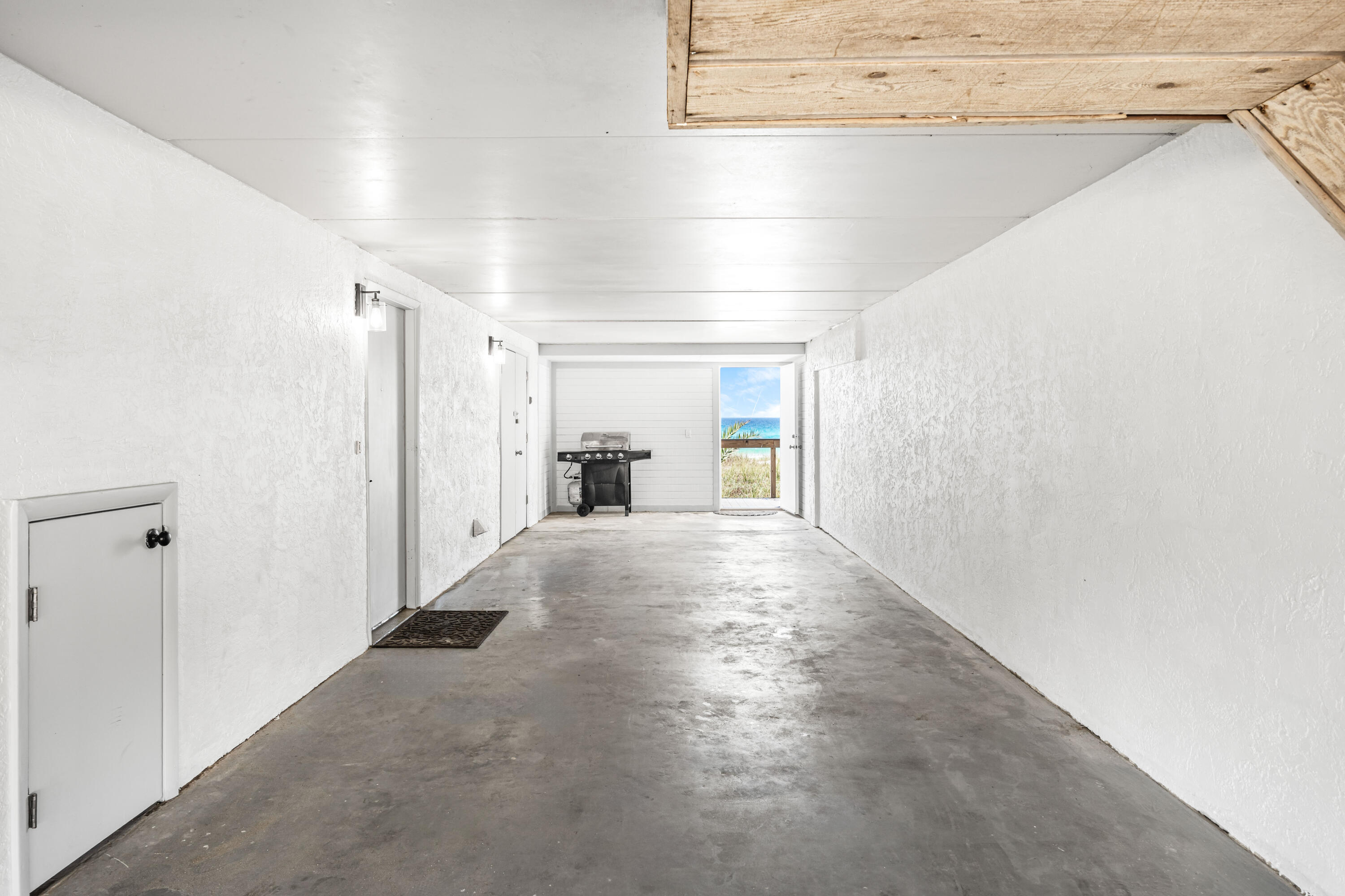 22519 Front Beach Road, Unit 108 Panama City Beach, FL 32413 - Photo 26 of 38 a view of a hallway with wooden floor and a cabinet